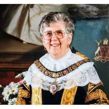 woman in glasses and mayoral robes